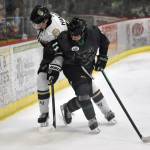 Joel Hanson of the Kenai River Brown Bears and Jakeb Lynch of the Minnesota Wilderness battle for the puck Saturday, Nov. 2, 2024, at the Soldotna Regional Sports Complex in Soldotna, Alaska. (Photo by Jeff Helminiak/Peninsula Clarion)