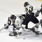 Kenai River Brown Bears goalie Leif Ekblad moves to cover the puck while teammates Brady Engelkes and Luke Hause try to keep Avery Anderson of the Minnesota Wilderness from scoring Saturday, Nov. 2, 2024, at the Soldotna Regional Sports Complex in Soldotna, Alaska. (Photo by Jeff Helminiak/Peninsula Clarion)