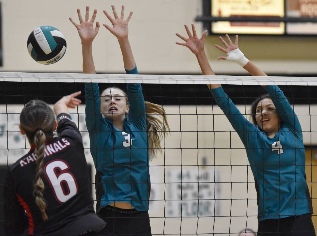 Nikiskis Blakeley Jorgensen and Alexa Iyatunguk put up a block on Kenai Centrals Stella Selanoff at the Southcentral Conference volleyball tournament at Nikiski Middle-High School in Nikiski, Alaska, on Saturday, Nov. 9, 2024. (Photo by Jeff Helminiak/Peninsula Clarion)