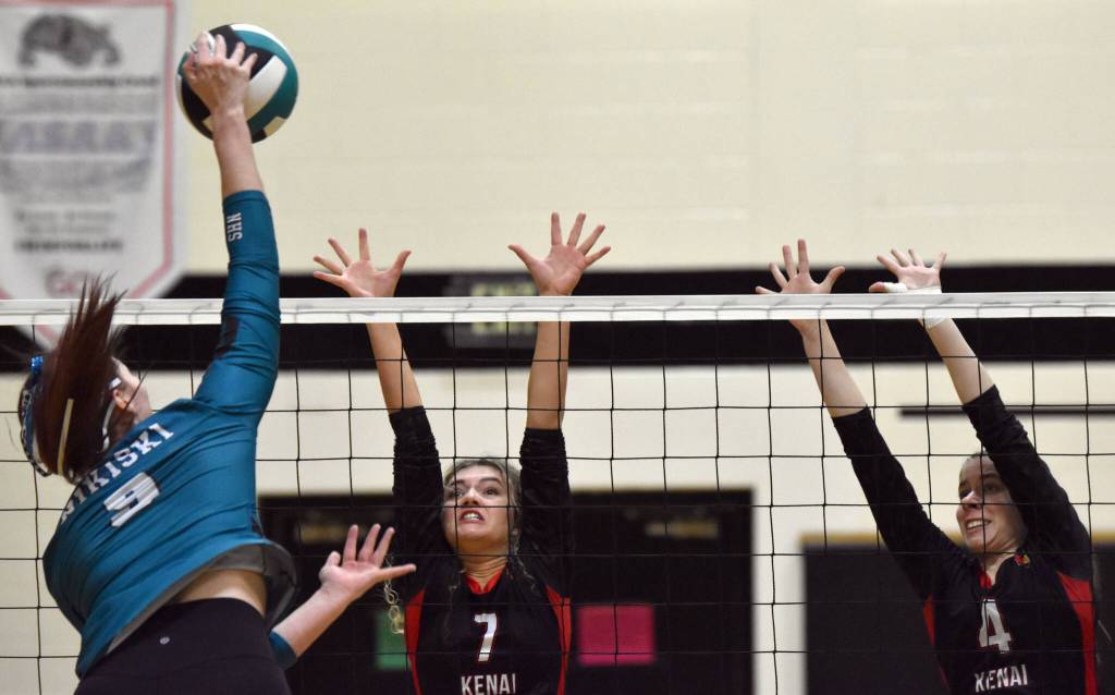 Nikiskis Ashlynne Playle attacks against Kenai Centrals Sophie Tapley and Avia Miller at the Southcentral Conference volleyball tournament at Nikiski Middle-High School in Nikiski, Alaska, on Saturday, Nov. 9, 2024. (Photo by Jeff Helminiak/Peninsula Clarion)