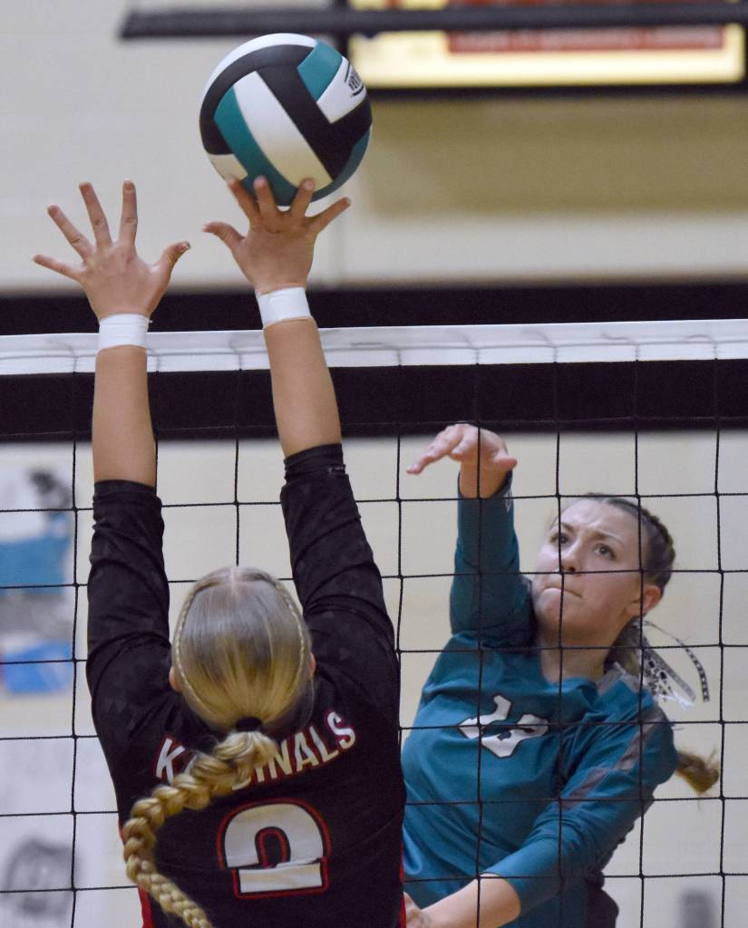 Nikiskis Mandee Roofe attacks against Kenai Centrals Kate Wisnewski at the Southcentral Conference volleyball tournament at Nikiski Middle-High School in Nikiski, Alaska, on Saturday, Nov. 9, 2024. (Photo by Jeff Helminiak/Peninsula Clarion)