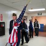The American Legion Post 20s color guard proceeds into the Mountain View Elementary gym in Kenai, Alaska, during a celebration of Veterans Day on Monday, Nov. 11, 2024. (Jake Dye/Peninsula Clarion)