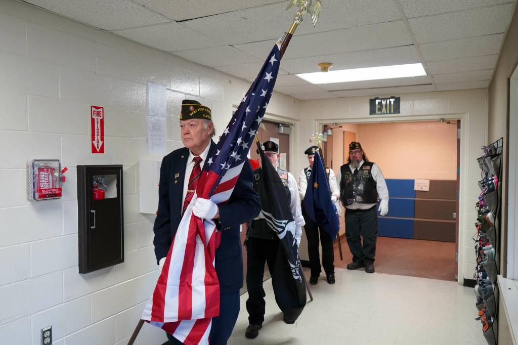 The American Legion Post 20s color guard proceeds into the Mountain View Elementary gym in Kenai, Alaska, during a celebration of Veterans Day on Monday, Nov. 11, 2024. (Jake Dye/Peninsula Clarion)