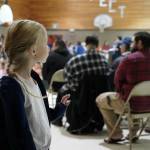 A student waves to veterans at Mountain View Elementary in Kenai, Alaska, during a celebration of Veterans Day on Monday, Nov. 11, 2024. (Jake Dye/Peninsula Clarion)