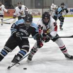 Chugiaks Callum Maghupoy and Kenai Centrals Avery Martin battle for the puck Thursday, Nov. 14, 2024, at the Kenai Multi-Purpose Facility in Kenai, Alaska. (Photo by Jeff Helminiak/Peninsula Clarion)