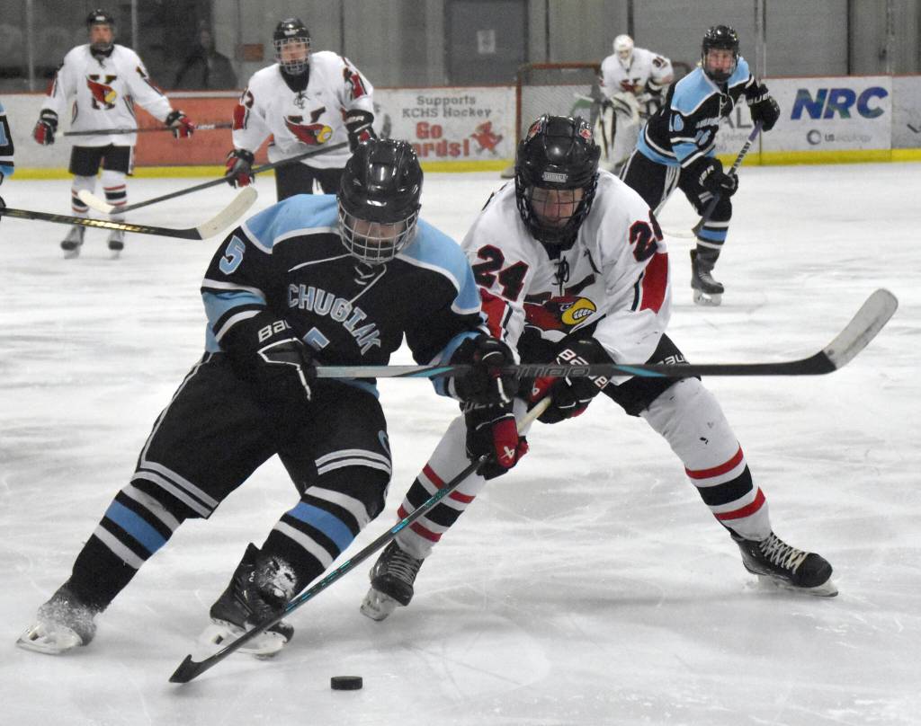 Chugiaks Callum Maghupoy and Kenai Centrals Avery Martin battle for the puck Thursday, Nov. 14, 2024, at the Kenai Multi-Purpose Facility in Kenai, Alaska. (Photo by Jeff Helminiak/Peninsula Clarion)