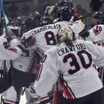 The Kenai Central hockey team mobs Logan Mese after Mese scored the game-winner in overtime against Chugiak on Thursday, Nov. 14, 2024, at the Kenai Multi-Purpose Facility in Kenai, Alaska. (Photo by Jeff Helminiak/Peninsula Clarion)