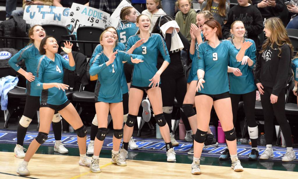 Nikiski players dance and look at the video scoreboard Saturday, Nov. 16, 2024, in the Class 3A state volleyball championship at the Alaska Airlines Center in Anchorage, Alaska. (Photo by Jeff Helminiak/Peninsula Clarion)