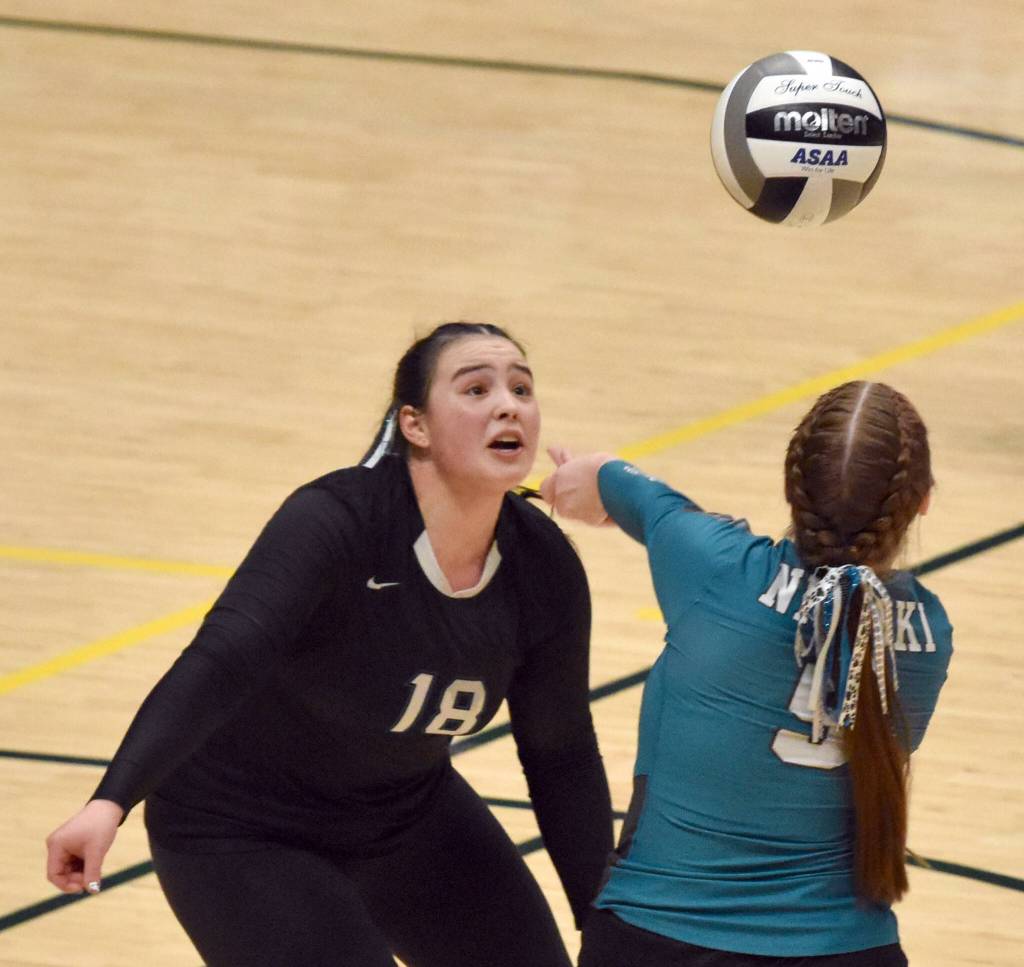Nikiskis Kailey Stynsberg watches as Avery Ellis digs up a ball Saturday, Nov. 16, 2024, in the Class 3A state volleyball championship at the Alaska Airlines Center in Anchorage, Alaska. (Photo by Jeff Helminiak/Peninsula Clarion)
