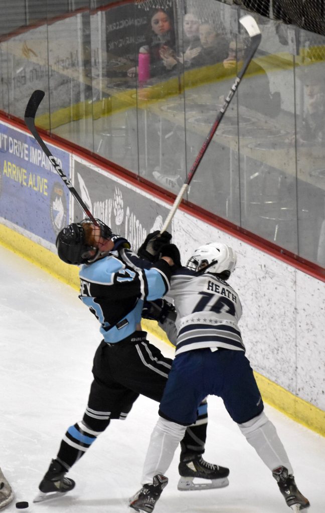 Soldotnas Daniel Heath and Chugiaks Cole Casey battle for the puck Friday, Nov. 15, 2024, at the Soldotna Regional Sports Complex in Soldotna, Alaska. (Photo by Jonas Oyoumick/Peninsula Clarion)