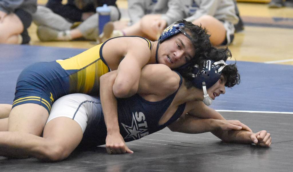 Homers Paul Minke wrestles to a pin of Soldotnas Harold Rudstrom on Tuesday, Nov. 19, 2024, at Soldotna High School in Soldotna, Alaska. (Photo by Jeff Helminiak/Peninsula Clarion)