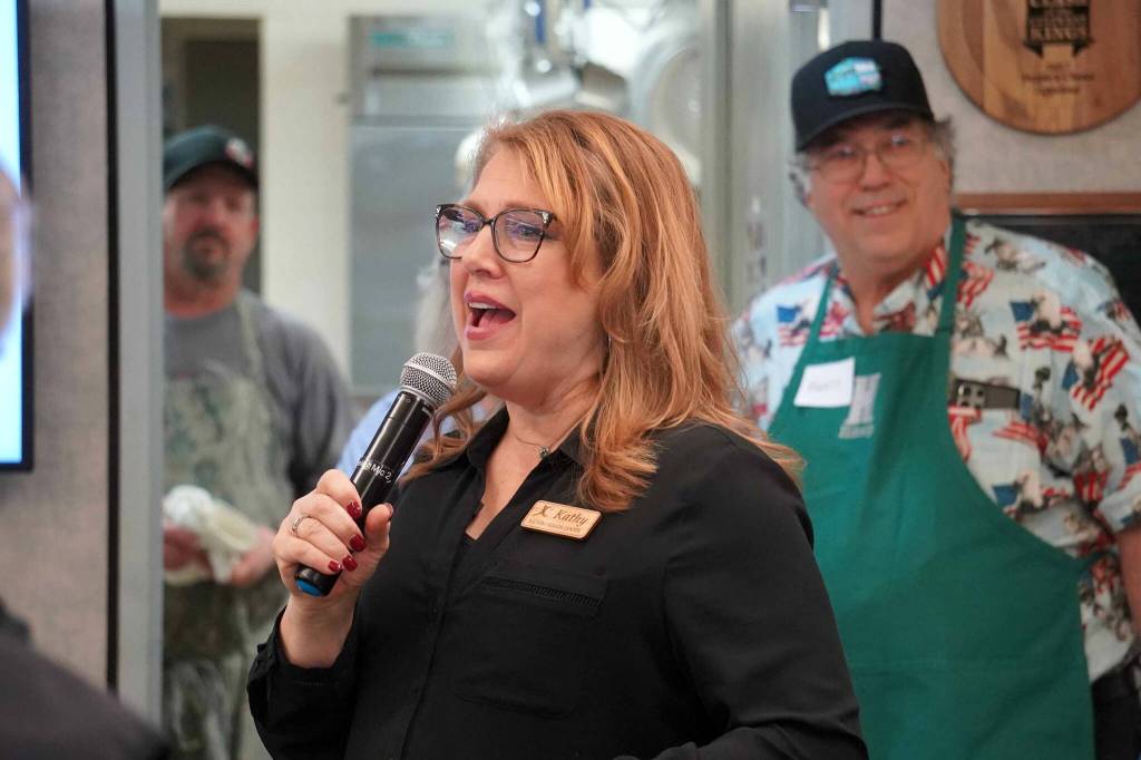 Kenai Senior Services Director Kathy Romain speaks ahead of the Hilcorp Areawide Senior Thanksgiving Luncheon in the Kenai Senior Center banquet hall in Kenai, Alaska, on Friday, Nov. 22, 2024. (Jake Dye/Peninsula Clarion)
