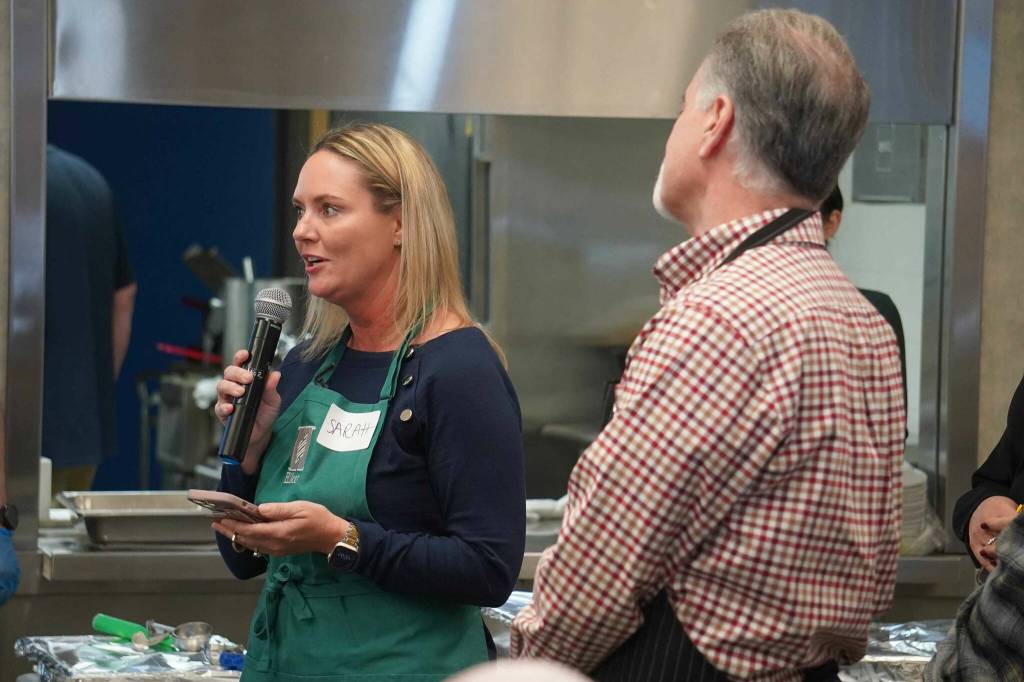 Sarah Lambert, community and engagement advisor for Hilcorp, speaks ahead of the Hilcorp Areawide Senior Thanksgiving Luncheon in the Kenai Senior Center banquet hall in Kenai, Alaska, on Friday, Nov. 22, 2024. (Jake Dye/Peninsula Clarion)