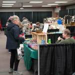 Shoppers browse wares at the 33rd Annual Holiday Bazaar at the Soldotna Regional Sports Complex in Soldotna, Alaska, on Friday, Nov. 22, 2024. (Jonas Oyoumick/Peninsula Clarion)