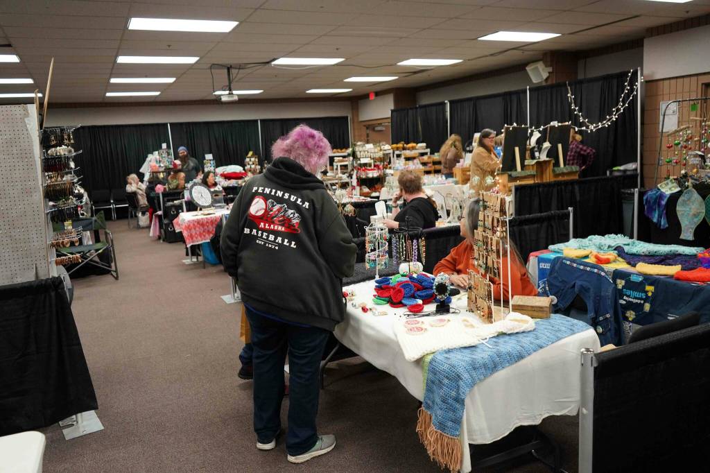 Shoppers browse wares at the 33rd Annual Holiday Bazaar at the Soldotna Regional Sports Complex in Soldotna, Alaska, on Friday, Nov. 22, 2024. (Jonas Oyoumick/Peninsula Clarion)