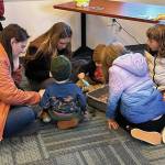 Families enjoyed exploring the sensory spider bin. (Photo courtesy Kenai National Wildlife Refuge)