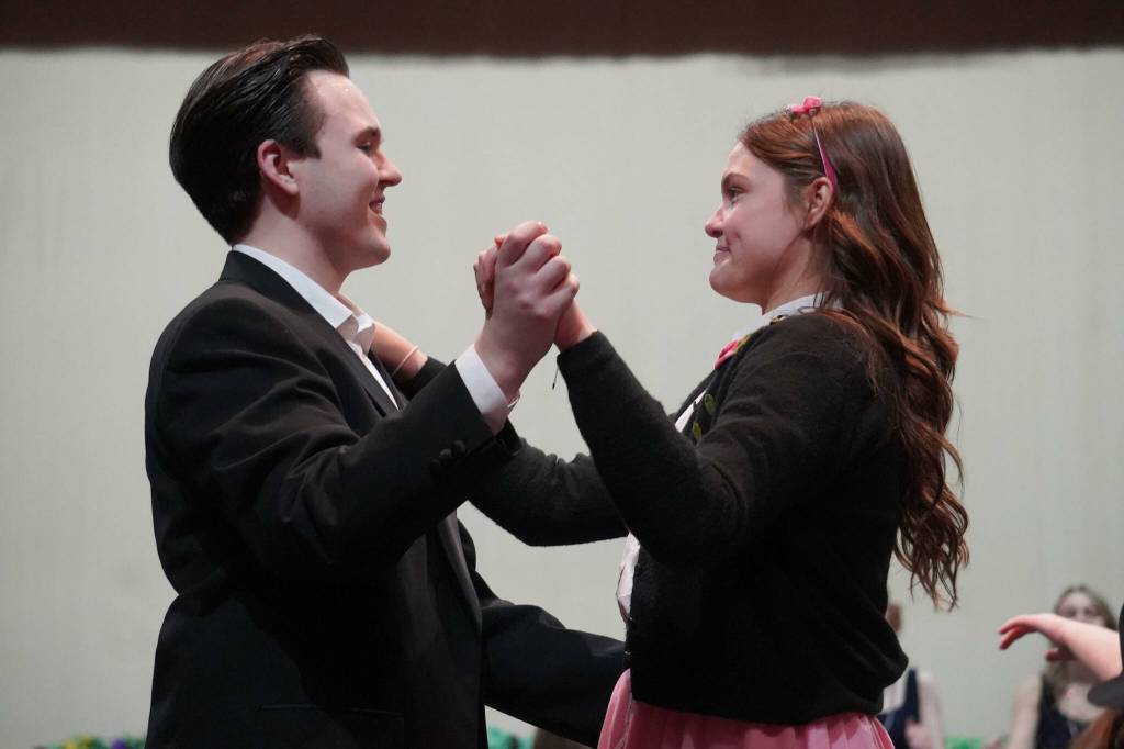 Scott Powell and Hannah Burton, of Soldotna High Schools Grease, rehearse in the Soldotna High School auditorium in Soldotna, Alaska, on Monday, Nov. 25, 2024. (Jake Dye/Peninsula Clarion)