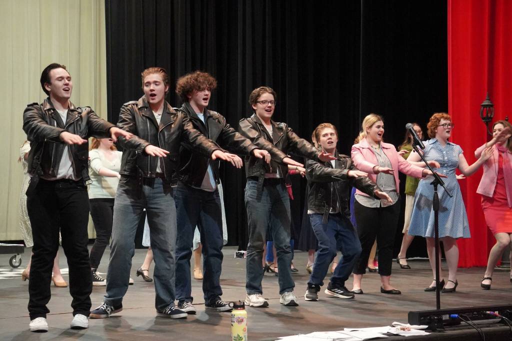 The cast of Soldotna High Schools Grease rehearse in the Soldotna High School auditorium in Soldotna, Alaska, on Monday, Nov. 25, 2024. (Jake Dye/Peninsula Clarion)