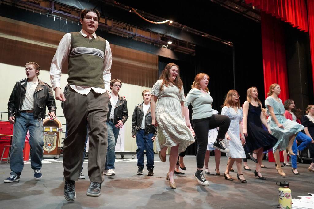 The cast of Soldotna High Schools Grease rehearse in the Soldotna High School auditorium in Soldotna, Alaska, on Monday, Nov. 25, 2024. (Jake Dye/Peninsula Clarion)