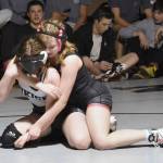 Kenai Centrals Rylee Kent works her way to a pin of Nikiskis Addison Perkins on Tuesday, Nov. 26, 2024, at Nikiski Middle-High School in Nikiski, Alaska. (Photo by Jeff Helminiak/Peninsula Clarion)