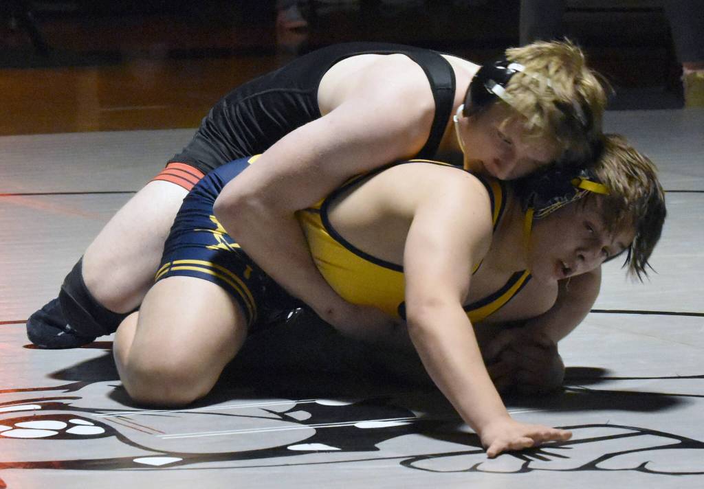 Kenai Centrals Thaddeus Lingenfelter works his pay to a win of Homers Gaius Taylor on Tuesday, Nov. 26, 2024, at Nikiski Middle-High School in Nikiski, Alaska. (Photo by Jeff Helminiak/Peninsula Clarion)