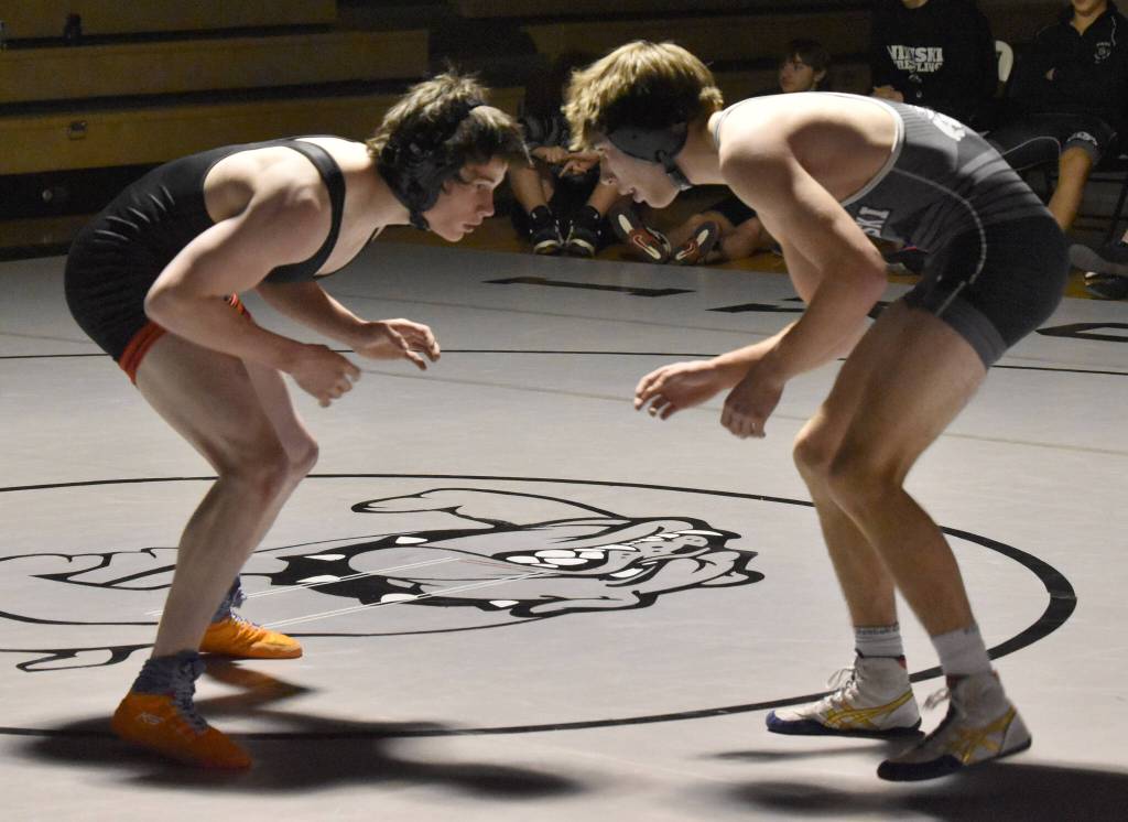 Nikiskis Wyatt Maguire works his way to a pin of Kenai Centrals Conner Cook on Tuesday, Nov. 26, 2024, at Nikiski Middle-High School in Nikiski, Alaska. (Photo by Jeff Helminiak/Peninsula Clarion)
