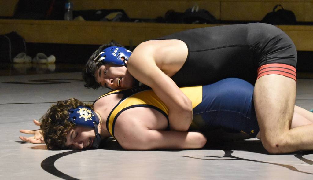 Kenai Centrals Atlas Ruark works his way to a 5-1 decision over Homers Alexander Van Meter on Tuesday, Nov. 26, 2024, at Nikiski Middle-High School in Nikiski, Alaska. (Photo by Jeff Helminiak/Peninsula Clarion)