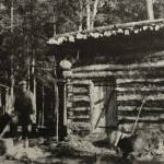 6DRobert Huttle (center) stands between an unidentified man (next to the dead eagle) and Andrew Berg, who probably helped his brother, Emil Berg, to build this log shed on Emils property just east of Indian Creek on Tustumena Lake. Huttle spent much of 1933-34 on the lake and documented many of its cabins and residents. It was in this shed, more than 40 years later, that Kerri Dolph sat, awaiting rescue after the death of her husband John. (Photo courtesy of the Robert Huttle Collection)