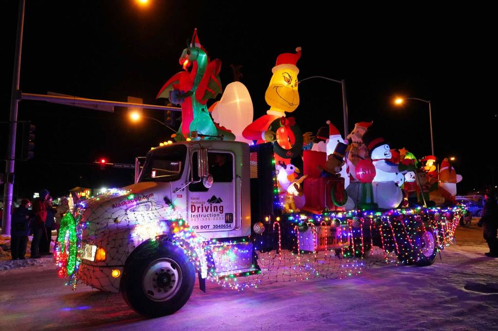 A Kenai Peninsula Driving Instruction truck covered in light-up inflatable characters rolls down Frontage Street in Kenai, Alaska, as part of the Electric Lights Parade on Friday, Nov. 29, 2024. (Jake Dye/Peninsula Clarion)
