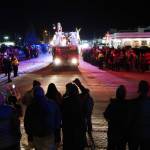 Santa Claus waves at paradegoers from atop a Kenai Fire Department engine on Frontage Street in Kenai, Alaska, as part of the Electric Lights Parade on Friday, Nov. 29, 2024. (Jake Dye/Peninsula Clarion)