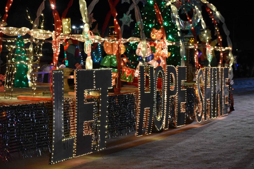 A brightly decorated float reads Let hope shine during the Electric Lights Parade on Frontage Street in Kenai, Alaska, on Friday, Nov. 29, 2024. (Jonas Oyoumick/Peninsula Clarion)
