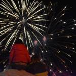 Children look up at exploding fireworks after the Electric Lights Parade at the Kenai Chamber of Commerce and Visitor Center in Kenai, Alaska, on Friday, Nov. 29, 2024. (Jonas Oyoumick/Peninsula Clarion)