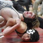 Nikiskis Wyatt Maguire and Kenai Centrals Gunnar Stanley wrestle Tuesday, Dec. 3, 2024, at Kenai Central High School in Kenai, Alaska. (Photo by Jeff Helminiak/Peninsula Clarion)