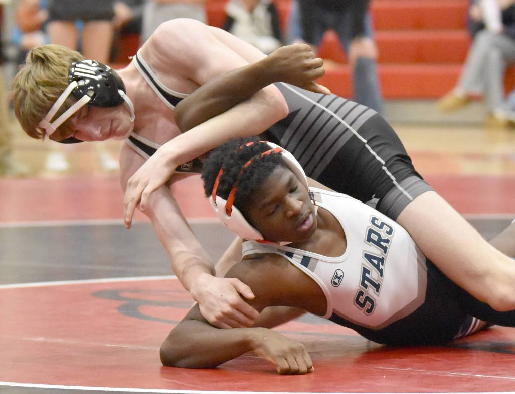 Nikiskis Spencer Peterkin and Soldotnas Sam Fredrickson wrestle Tuesday, Dec. 3, 2024, at Kenai Central High School in Kenai, Alaska. (Photo by Jeff Helminiak/Peninsula Clarion)