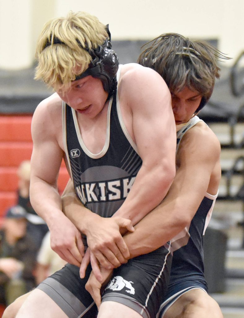 Nikiskis Darren Powell and Soldotnas Mason Bock wrestle Tuesday, Dec. 3, 2024, at Kenai Central High School in Kenai, Alaska. (Photo by Jeff Helminiak/Peninsula Clarion)