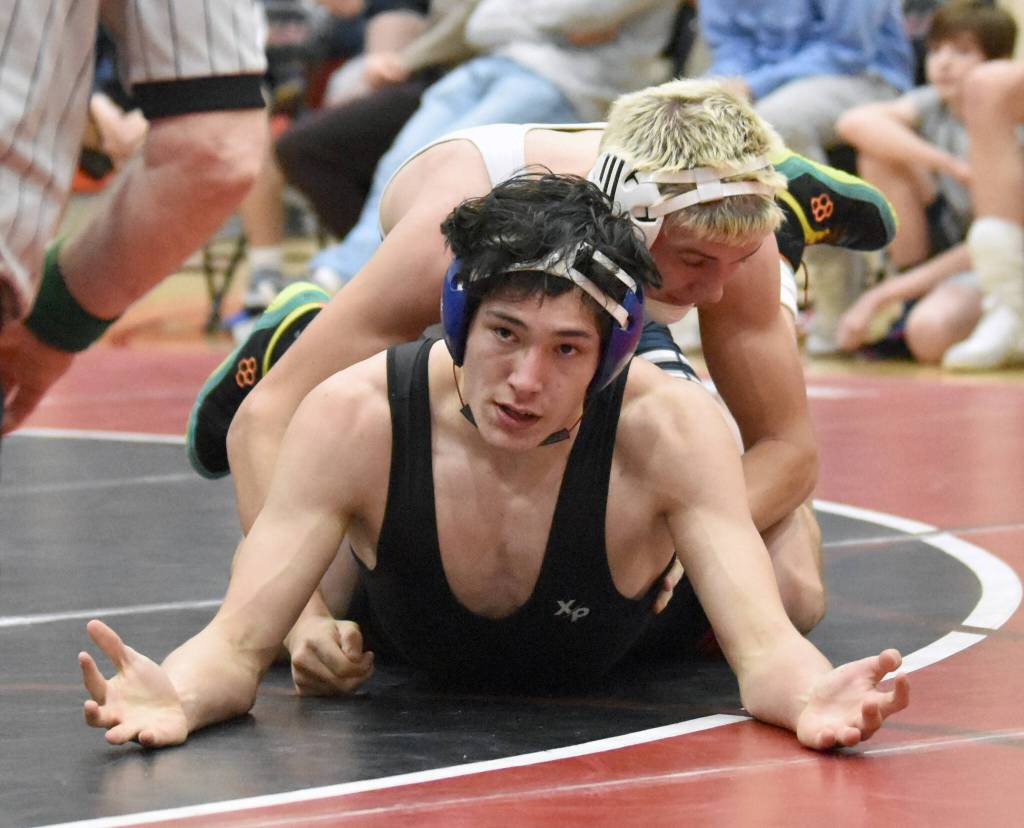 Kenai Centrals Atlas Ruark and Soldotnas Trevor Michael wrestle Tuesday, Dec. 3, 2024, at Kenai Central High School in Kenai, Alaska. (Photo by Jeff Helminiak/Peninsula Clarion)