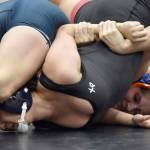 Kenai Central's Jadeyn Jacko and Soldotna's Mia Hannevold wrestle Tuesday, Dec. 4, 2024, at Kenai Central High School in Kenai, Alaska. (Photo by Jeff Helminiak/Peninsula Clarion)