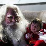 Harley St. Clair, 5 weeks old, meets Santa Claus for the first time at Christmas in the Park at Soldotna Creek Park in Soldotna, Alaska, on Saturday, Dec. 7, 2024. (Jake Dye/Peninsula Clarion)