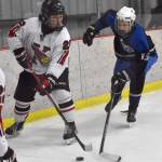 Kenai Centrals Cameron Cowie holds the puck from Palmers Kellen Kinneen on Saturday, Dec. 7, 2024, at the Kenai Multi-Purpose Facility in Kenai, Alaska. (Photo by Jeff Helminiak/Peninsula Clarion)