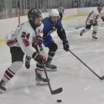 Kenai Centrals Avery Martin attacks against Palmers Riley Swanson on Saturday, Dec. 7, 2024, at the Kenai Multi-Purpose Facility in Kenai, Alaska. (Photo by Jeff Helminiak/Peninsula Clarion)