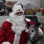 Blue sits for a photo with Santa during Bark, Block and Bowl on Saturday, Dec. 10, 2022 at the Kenai Peninsula Food Bank in Soldotna, Alaska. (Jake Dye/Peninsula Clarion)
