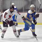 Kenai Centrals William Howard and Kodiaks Miles Grimes battle for the puck Thursday, Dec. 12, 2024, at the Kenai Multi-Purpose Facility in Kenai, Alaska. (Photo by Jeff Helminiak/Peninsula Clarion)