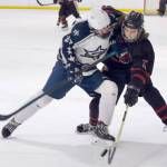 Soldotnas Keegan Myrick and Juneau-Douglas sophomore Caden Morris battle for a puck during a 4-3 Crimson Bears loss to the visiting Stars on Friday, Dec. 13, 2024, at Treadwell Ice Arena in Juneau, Alaska. (Klas Stolpe / Juneau Empire)