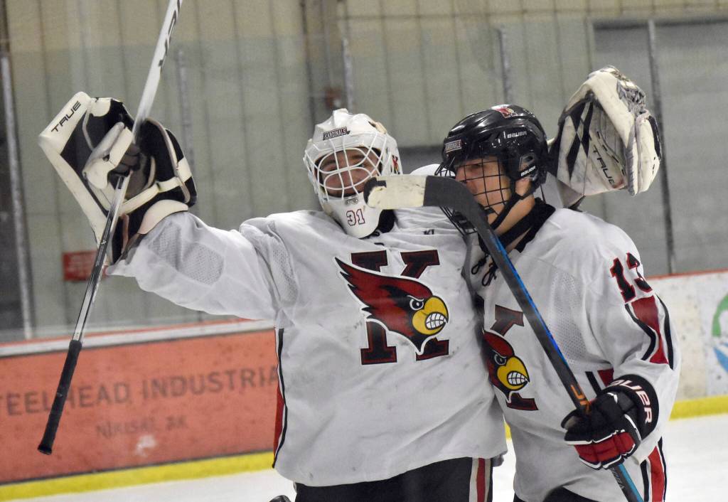 Kenai Central goalie Evyn Witt and William Howard celebrate a victory over Soldotna on Tuesday, Dec. 17, 2024, at the Kenai Multi-Purpose Facility in Kenai, Alaska. (Photo by Jeff Helminiak/Peninsula Clarion)