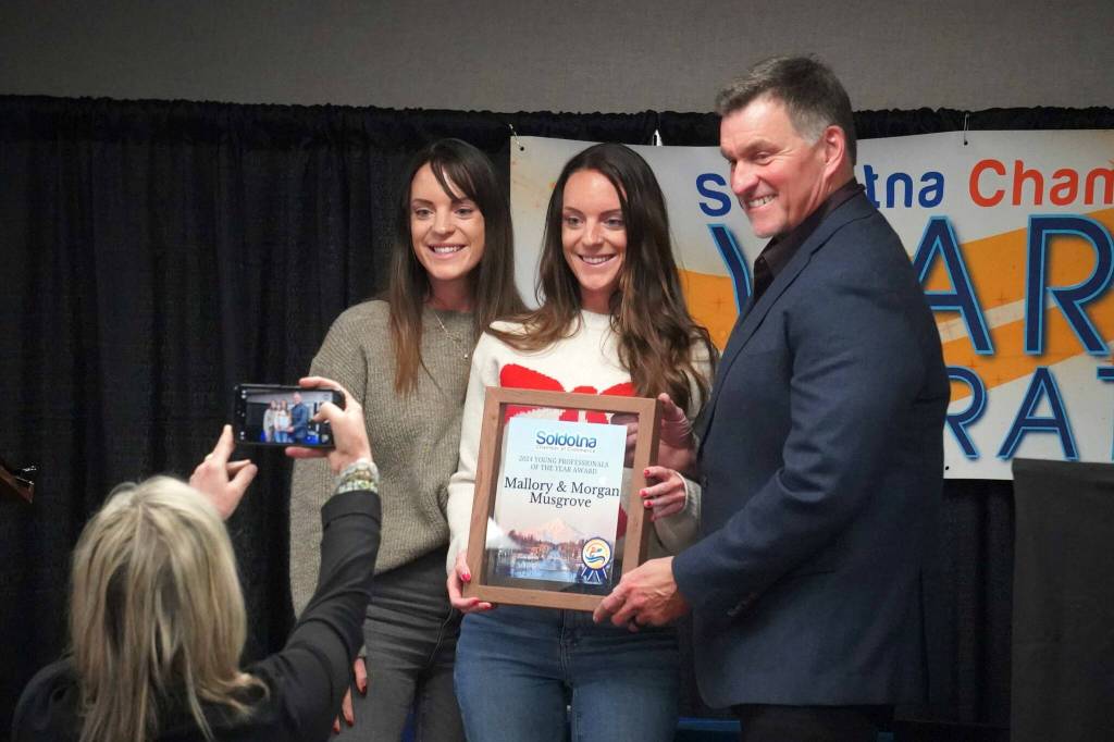 Mallory and Morgan Musgrove are recognized as Young Professionals of the Year during the 65th Annual Soldotna Chamber Awards Celebration at the Soldotna Regional Sports Complex in Soldotna, Alaska, on Wednesday, Dec. 18, 2024. (Jake Dye/Peninsula Clarion)