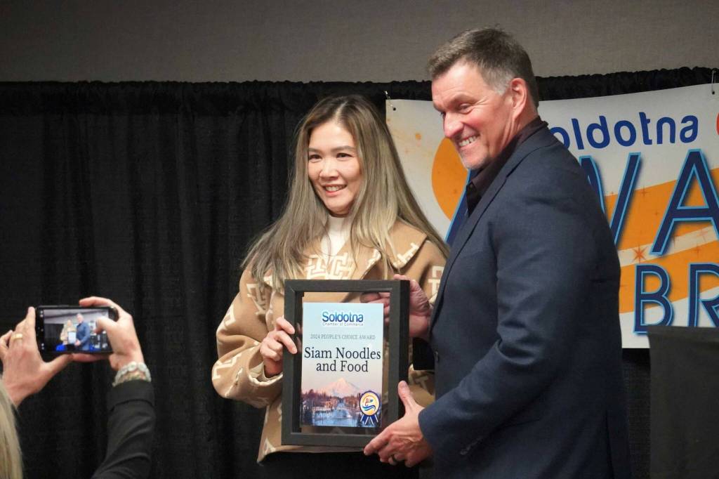 Suwannasa Piwon receives the Peoples Choice Award on behalf of Siam Noodles and Food during the 65th Annual Soldotna Chamber Awards Celebration at the Soldotna Regional Sports Complex in Soldotna, Alaska, on Wednesday, Dec. 18, 2024. (Jake Dye/Peninsula Clarion)