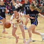 Kenai Centrals Evelyn Cooper keeps the ball away from Palmers Mariah Bothwell on Thursday, Dec. 19, 2024, at Kenai Central High School in Kenai, Alaska. (Photo by Jeff Helminiak/Peninsula Clarion)
