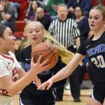 Kenai Central's Bryleigh Williams drives against Palmer's Kaylyn Miller and Jasmine Hephner on Thursday, Dec. 19, 2024, at Kenai Central High School in Kenai, Alaska. (Photo by Jeff Helminiak/Peninsula Clarion)
