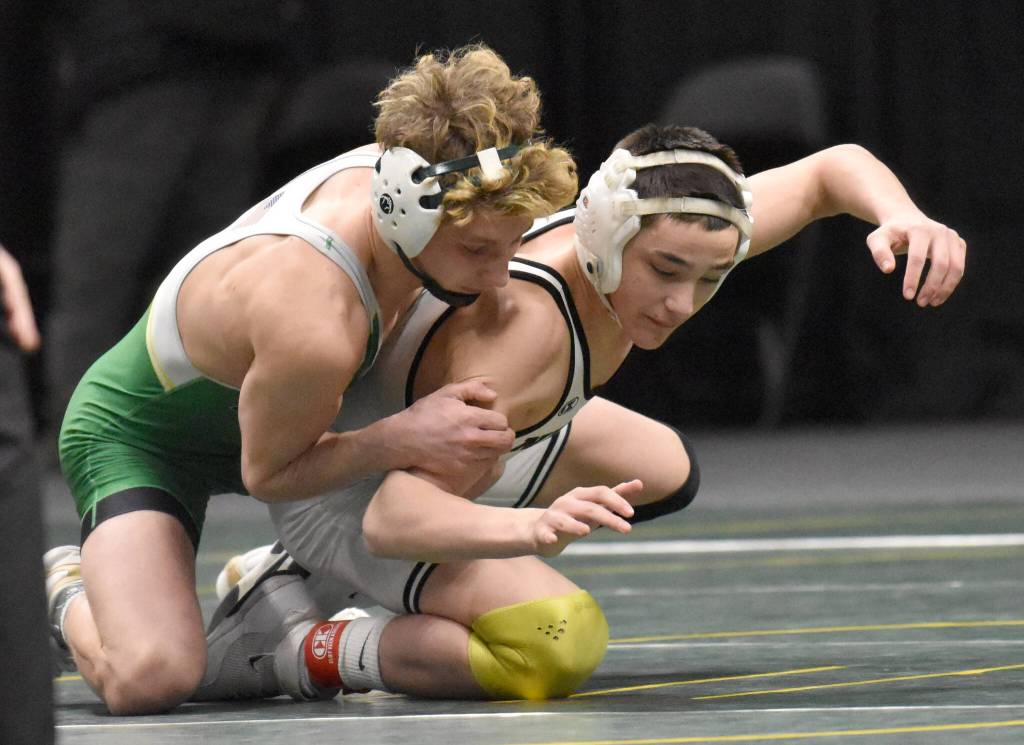 Sewards Hunter Forshee-Kurtz wrestles to an 8-5 decision over Nikiskis Jaxson Young in the final at 135 pounds at the Division II state wrestling tournament Saturday, Dec. 21, 2024, at the Alaska Airlines Center in Anchorage, Alaska. (Photo by Jeff Helminiak/Peninsula Clarion)