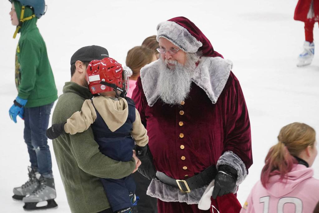 Santa Claus greets children during Skate with Santa at the Soldotna Regional Sports Complex in Soldotna, Alaska, on Saturday, Dec. 21, 2024. (Jake Dye/Peninsula Clarion)